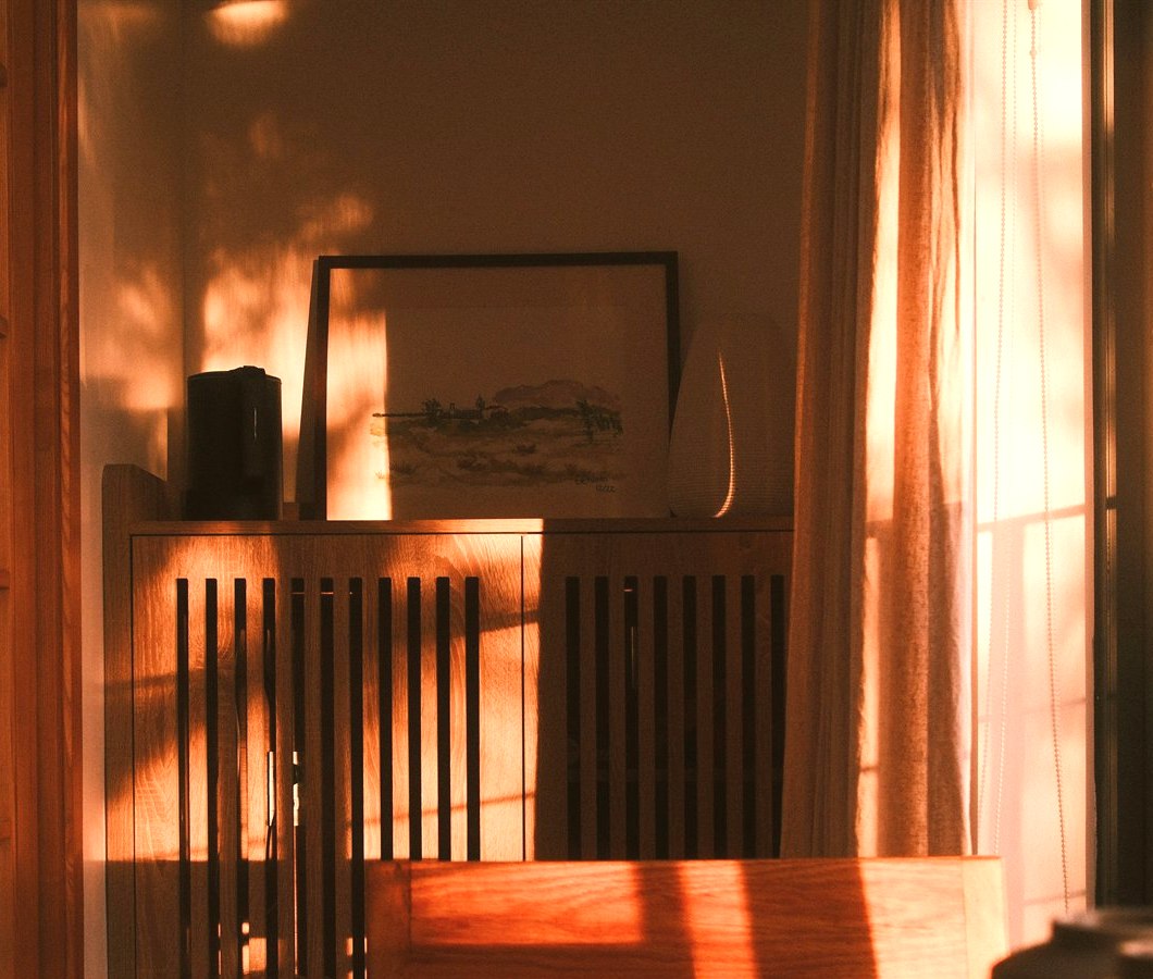 Warm interior window light suggesting a quiet home reflection